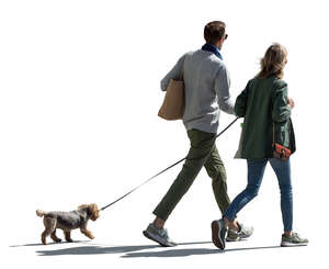 cut out couple with a dog walking in the street