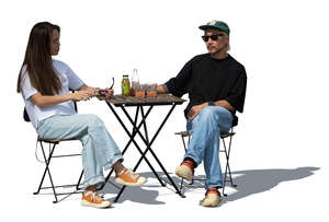 asian woman and man sitting in a street cafe in summer