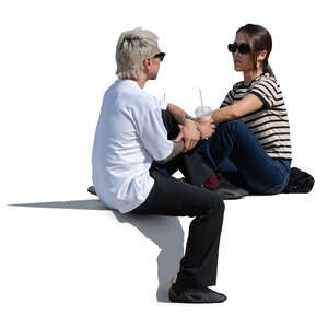 man and woman sitting outside and drinking ice coffees