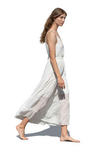 cut out woman in a white summer dress walking barefoot