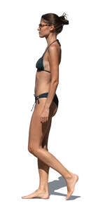 woman in a bikini walking in side view