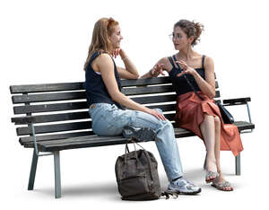 two women sitting on the bench and talking