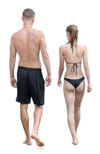 man and woman at the beach in swimming clothing walking