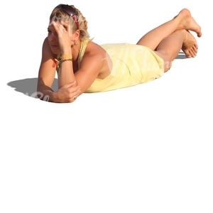 woman in a yellow dress lying on the beach