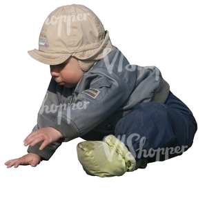 small boy playing on the ground