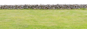 stone fence by a grass field