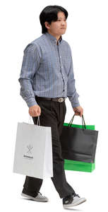 asian man with shopping bags walking