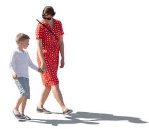 backlit image of a a mother and son walking