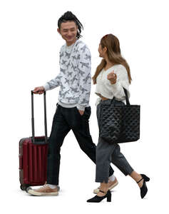 two cut out young asian people with travelling bags walking