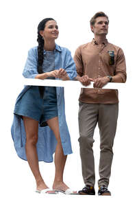 cut out man and woman standing on a balcony