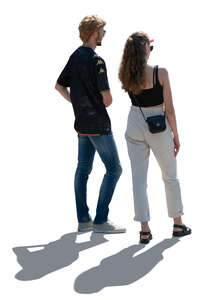 two backlit people standing and looking at smth