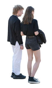 two people standing and looking down at smth