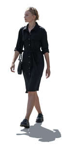 cut out backlit woman in a black dress walking
