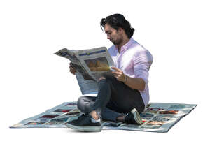 man sitting under the tree and reading a newspaper
