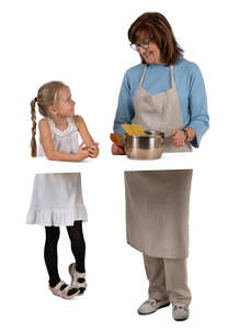 grandmother and granddaughter cooking in the kitchen
