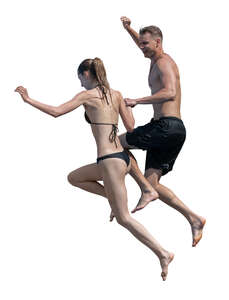 man and woman jumping into the pool together