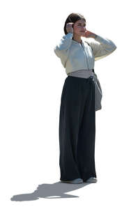 cut out backlit young woman standing