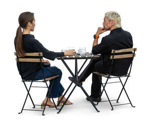east asian man and woman sitting in a cafe