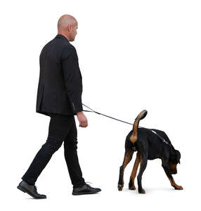 cut out man in a black suit walking a dog