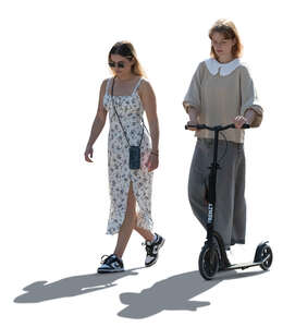 backlit women with a scooter walking in the summer