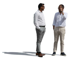 two men in white shirts standing and talking