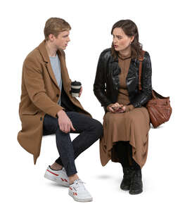 two cut out people sitting and talking and drinking coffee