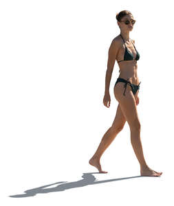 cut out backlit woman at the beach walking
