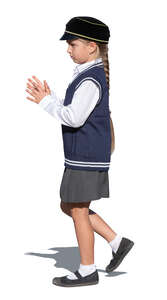little schoolgirl in a school uniform walking