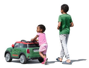 two cut out kids with a toy car walking