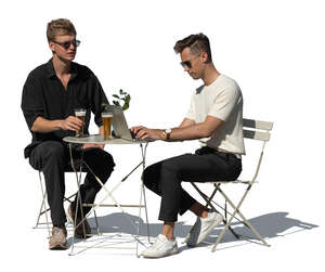 two cut out men sitting in an outdoor cafe and drinking beer