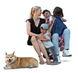 family sitting happily together with a dog lying nearby