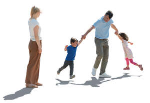 backlit scene of a father playing with children and mom watching