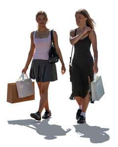 two cut out backlit teenage girls coming from shopping