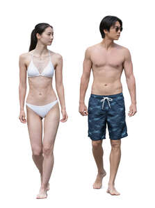 asian man and woman walking at the beach