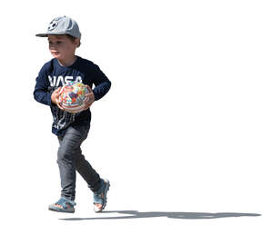 cut out sidelit little boy with a hat running