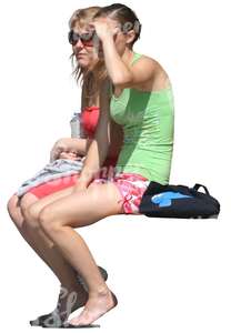 two cut out women sitting and looking at smth