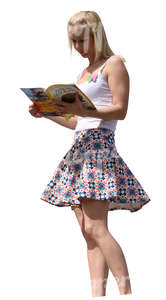 woman standing on a balcony and reading a magazine