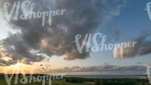 time lapse video of a sunset with sun rays over the fields