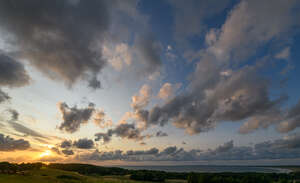 sunset with some sun shining through the clouds