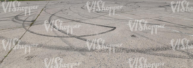 light grey concrete ground with tyre tracks