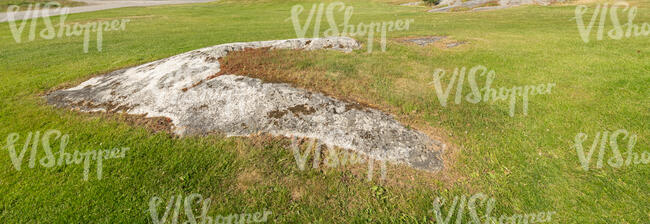 mowed lawn with a rocky patch