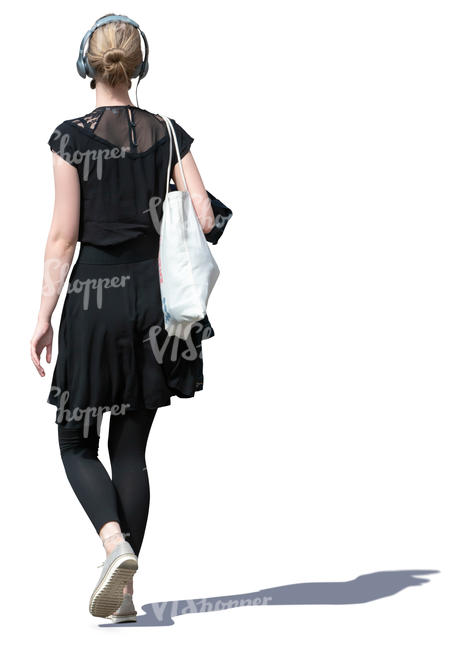 young woman with headphones walking