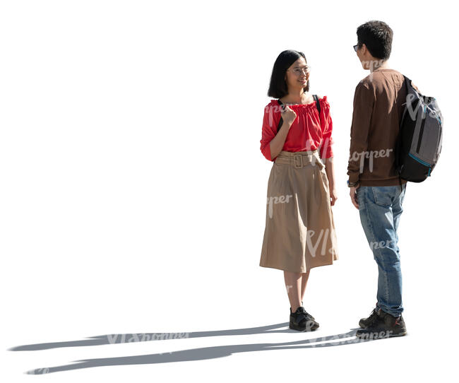 two cut out backlit people standing and talking