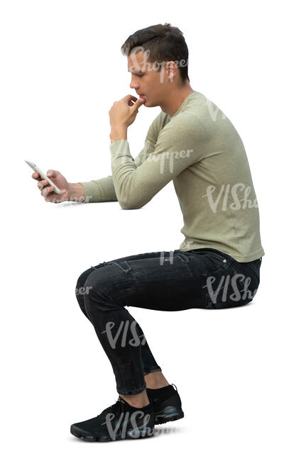 cut ou man sitting at a table and reading smth from his phone