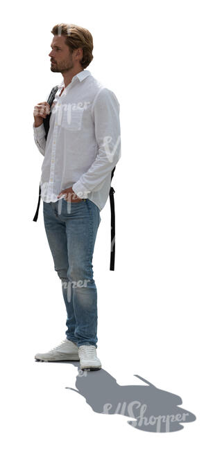 backlit man in white shirt and jeans standing