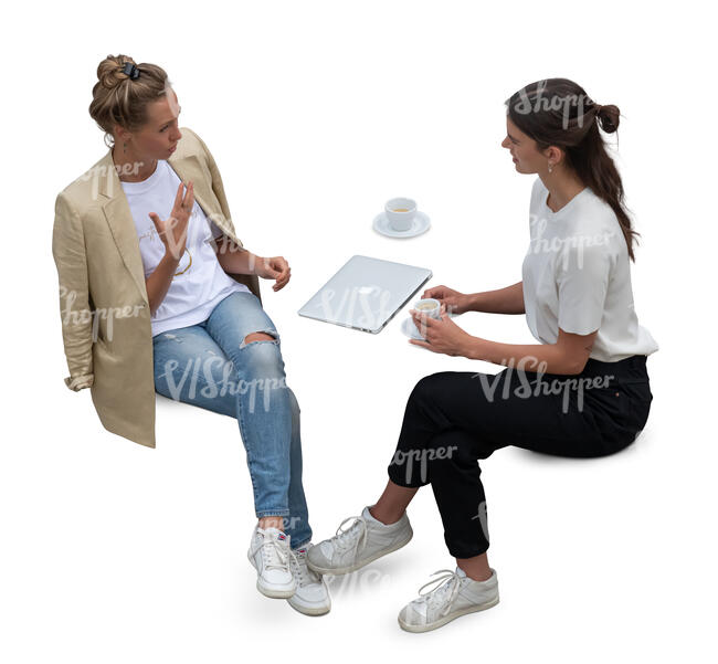 top view of two women sitting and drinking coffee