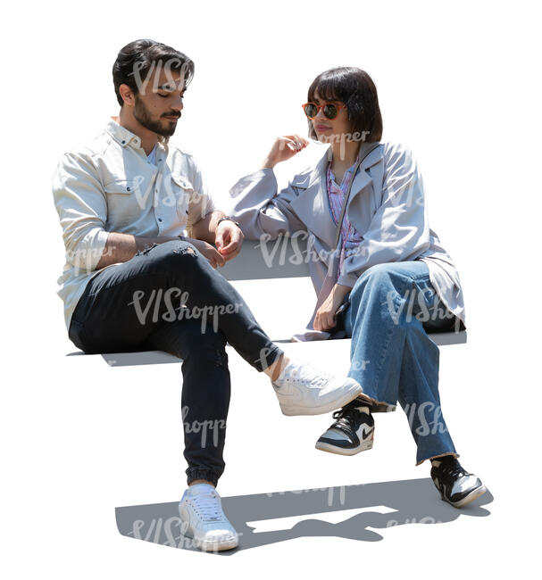 backlit man and woman sitting and talking