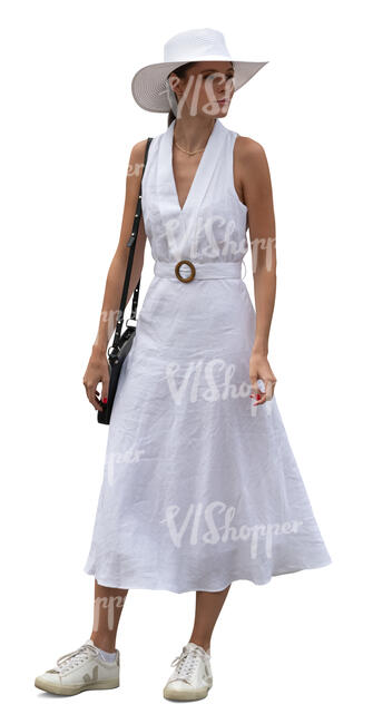 woman in a white dress and wearing a hat standing