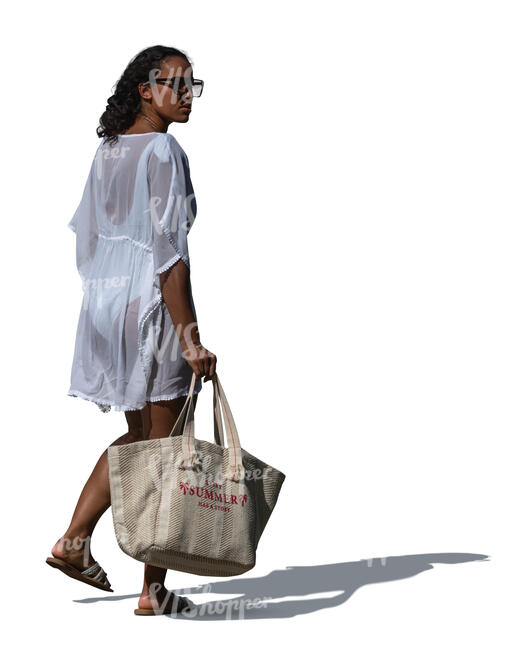 cut out woman in a light beach dress going to the beach