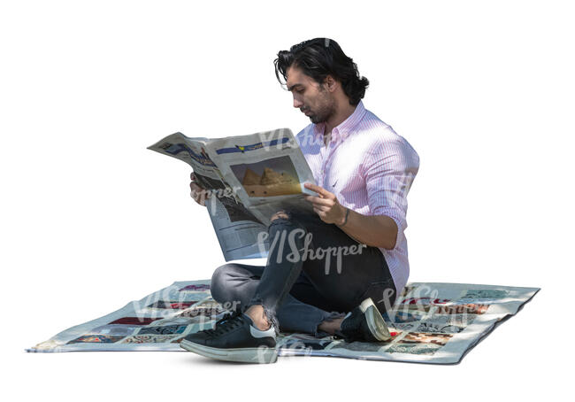 man sitting under the tree and reading a newspaper